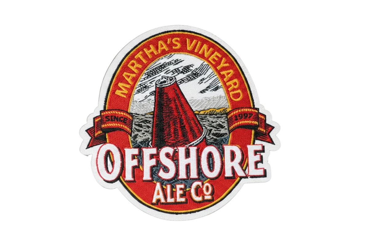 An embroidered circular patch for Martha's Vineyard Offshore Ale Co., featuring a red wine bottle illustration, white lettering, and a red, white, and blue background.