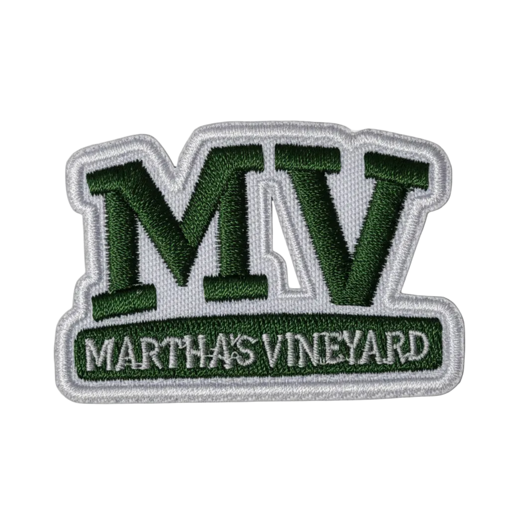 An embroidered patch featuring the letters 'MV' in dark green with a silver outline, and a bottom banner reading 'MARTHA'S VINEYARD' in white text on a green background.